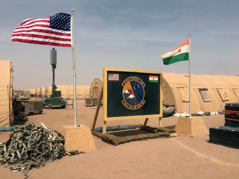 A U.S. and Niger flag are raised side by side at the base camp for air forces and other personnel supporting the construction of Niger Air Base 201 in Agadez, Niger