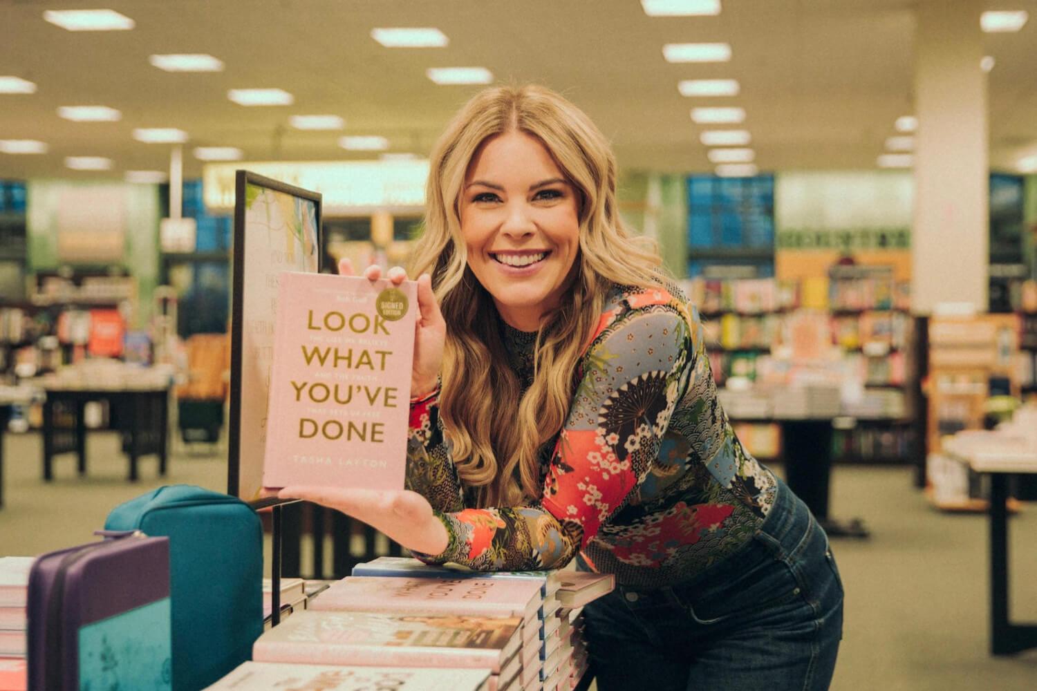 Tasha Layton smiling in a bookstore