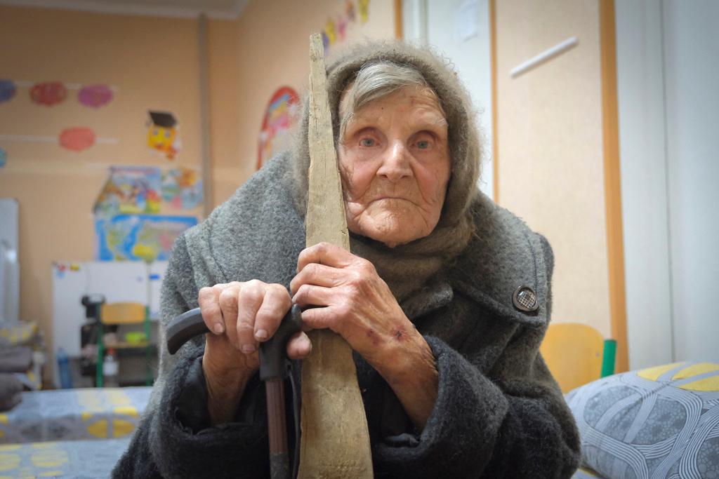 In this photo provided by the Ukrainian National Police of Donetsk region, 98-year-old Lidia Lomikovska sits in a shelter after she escaped Russian-occupied territory in the Donetsk region, Ukraine, April 26, 2024.