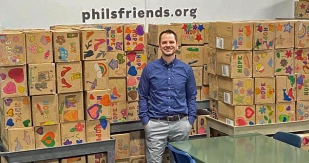 Phil stands with dozens of hand decorated hope boxes