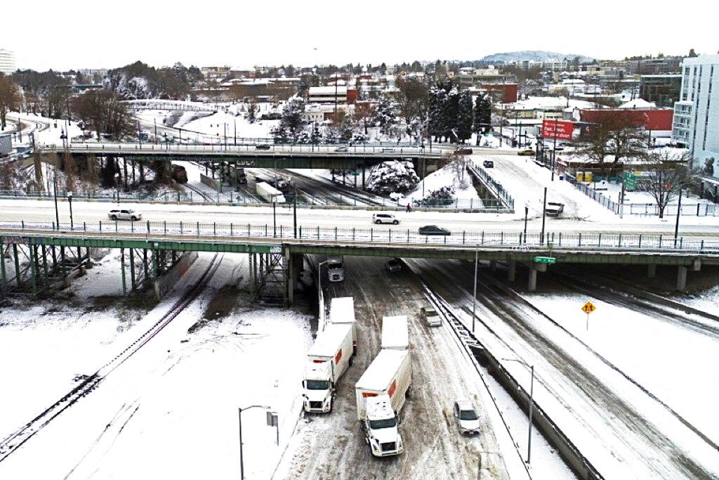 The area where Interstate 5 and I-84 meetup is covered in snow on Thursday, Feb. 23,2023 in Portland, Ore