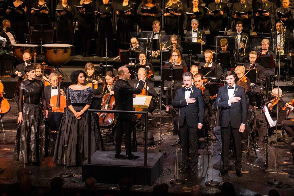 This photo provided by Metropolitan Opera, Met music director Yannick Nézet-Séguin leads mezzo-soprano Emily D’Angelo, soprano Golda Schultz, tenor Dmytro Popov, and bass-baritone Vladyslav Buialskyi in the National Anthem of Ukraine during "For Ukraine: A Concert of Remembrance and Hope" on Friday, Feb. 24, 2023 in New York.