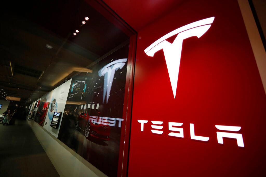  A sign bearing the Tesla company logo is displayed outside a Tesla store in Cherry Creek Mall in Denver, Colorado.