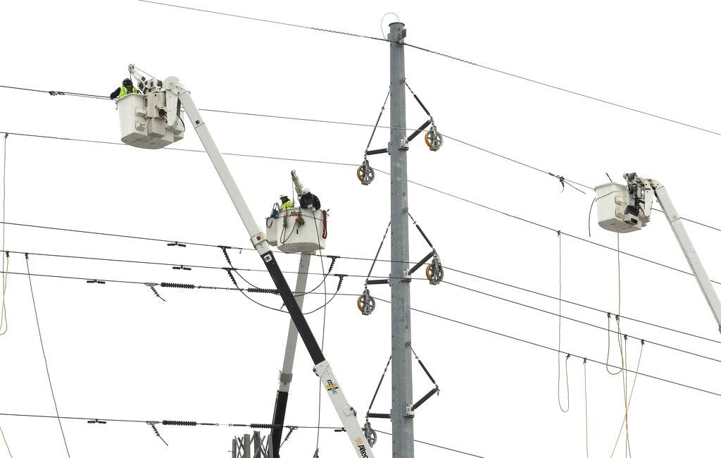 ITC Transmission, a subsidiary of DTE Energy, basket trucks work on power lines along 8 Mile, near Wanda in Ferndale, Mich. on Saturday, Feb. 25, 2023. 