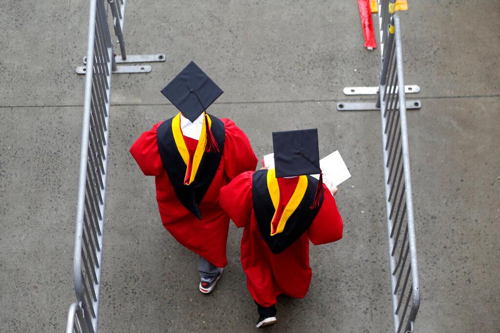 New graduates walk into the High Point Solutions Stadium before the start of the Rutgers University graduation ceremony in Piscataway Township, N.J.