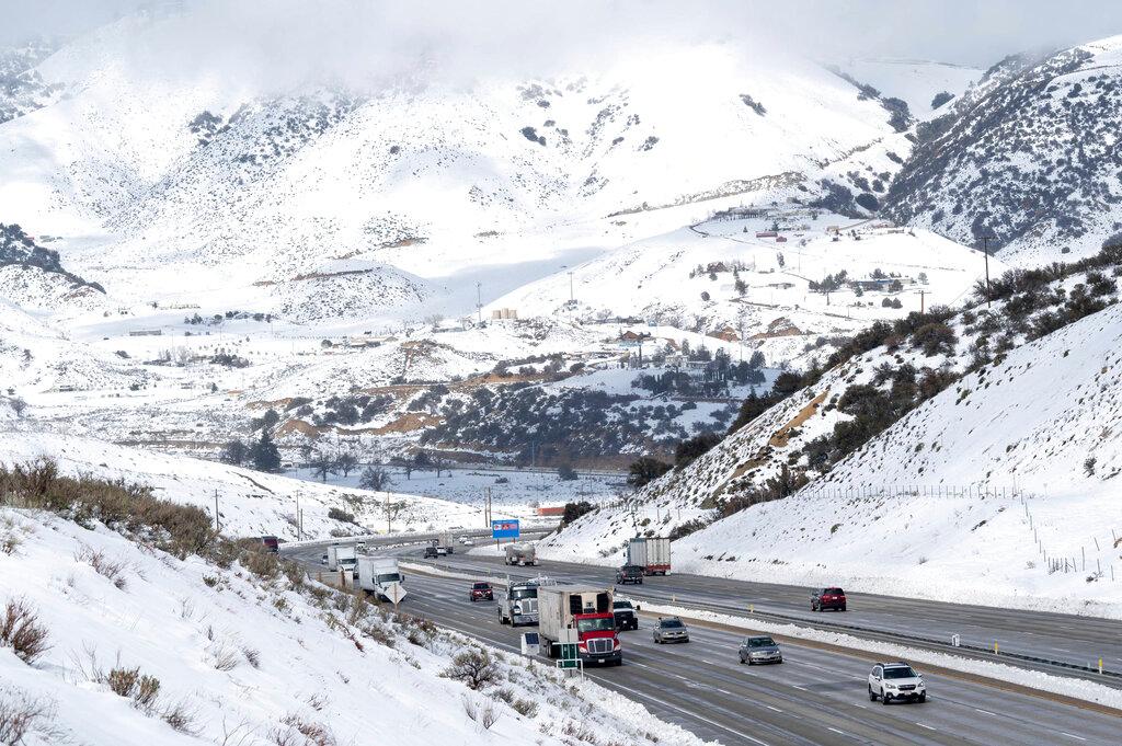 Snow surrounds the I-5 freeway through Gorman, Calif.