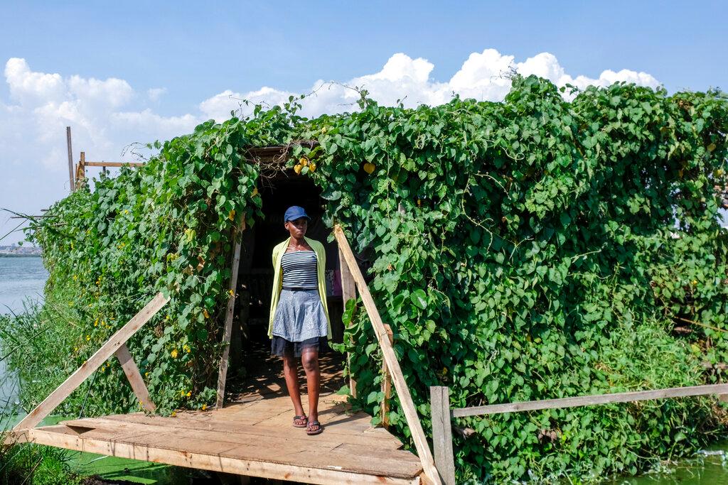 A woman stands at the entrance to a floating restaurant and bar, on Lake Victoria near the Luzira area of Kampala, Uganda Sunday, Feb. 19, 2023.