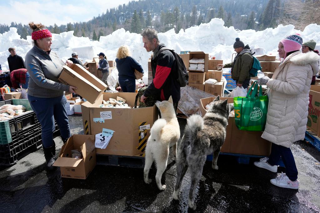 Food is distributed out of a parking lot after a series of storms in Crestline, Calif. 