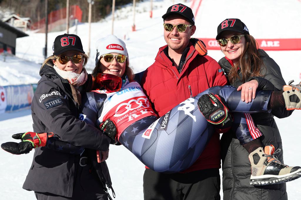 Brother Taylor, flanked by his wife Christie, right, and by her mother Eileen, left, holds the winner United States' Mikaela Shiffrin after an alpine ski, women's World Cup slalom, in Are, Sweden, Saturday, March 11, 2023.