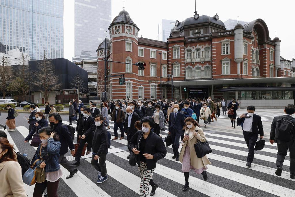 Japan ends mask mandate, but most still wear them