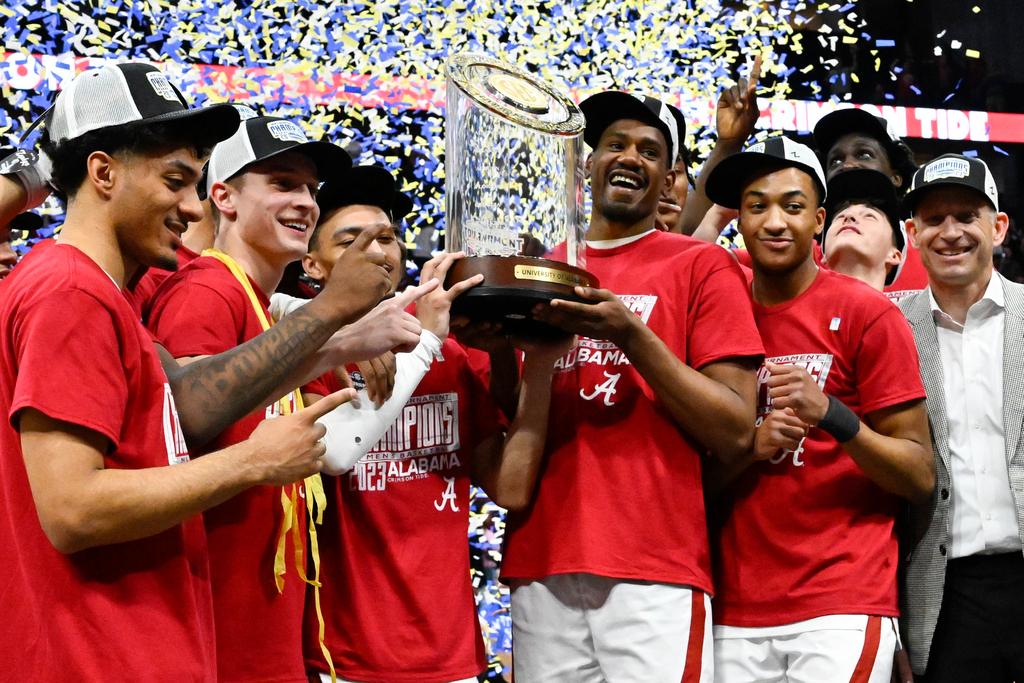 Alabama players pose with the trophy after an NCAA college basketball game against Texas A&M in the finals of the Southeastern Conference Tournament