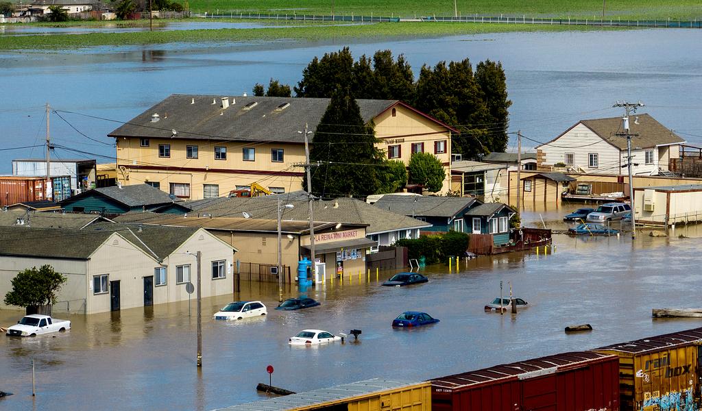 Floodwaters surround homes and vehicles in the community of Pajaro in Monterey County, Calif.