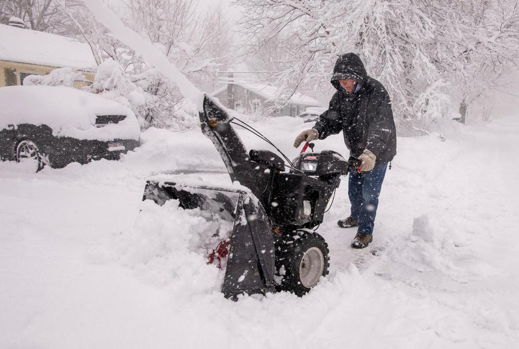 Paul Horgan clears his driveway for the second time this morning as more than a foot of snow has fallen in Northern Worcester County