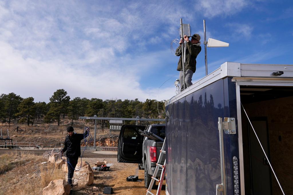 Brothers Parker and Carver Cammans install cloud seeding equipment Saturday, Dec. 3, 2022, in Lyons, Colo.