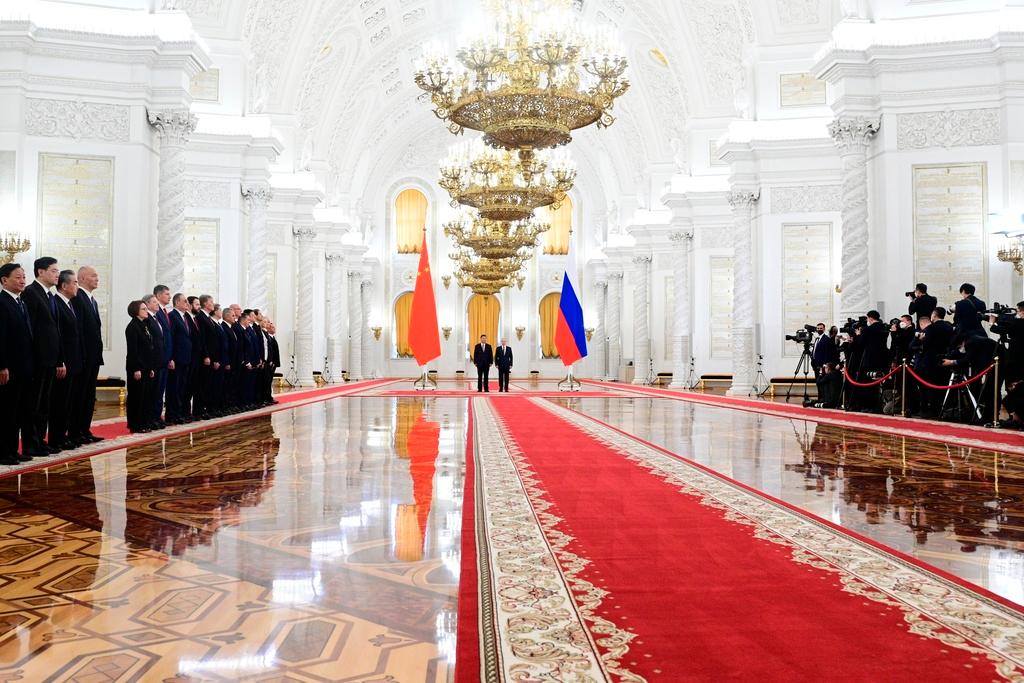 Russian President Vladimir Putin, foreground right, and Chinese President Xi Jinping, foreground left, attend an official welcome ceremony at The Grand Kremlin Palace, in Moscow