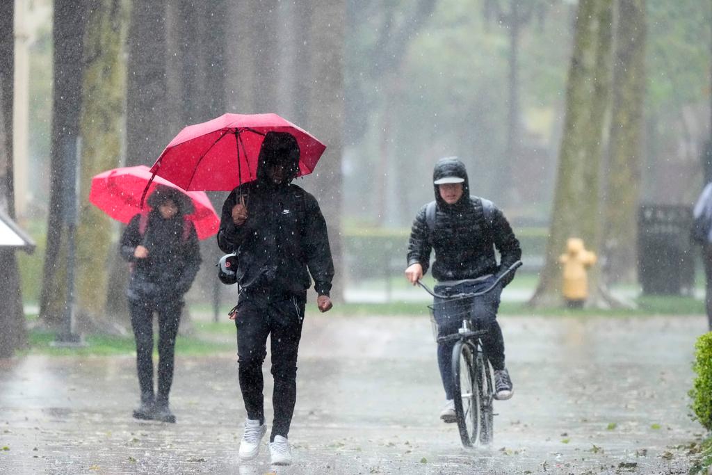 Rain falls on pedestrians on the University of Southern California campus in Los Angeles