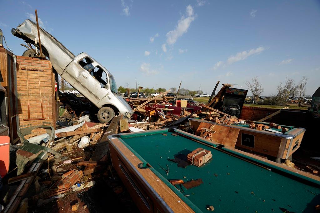 A pickup truck rests on top of a restaurant cooler at Chuck's Dairy Cafe in Rolling Fork, Miss., Saturday, March 25, 2023.