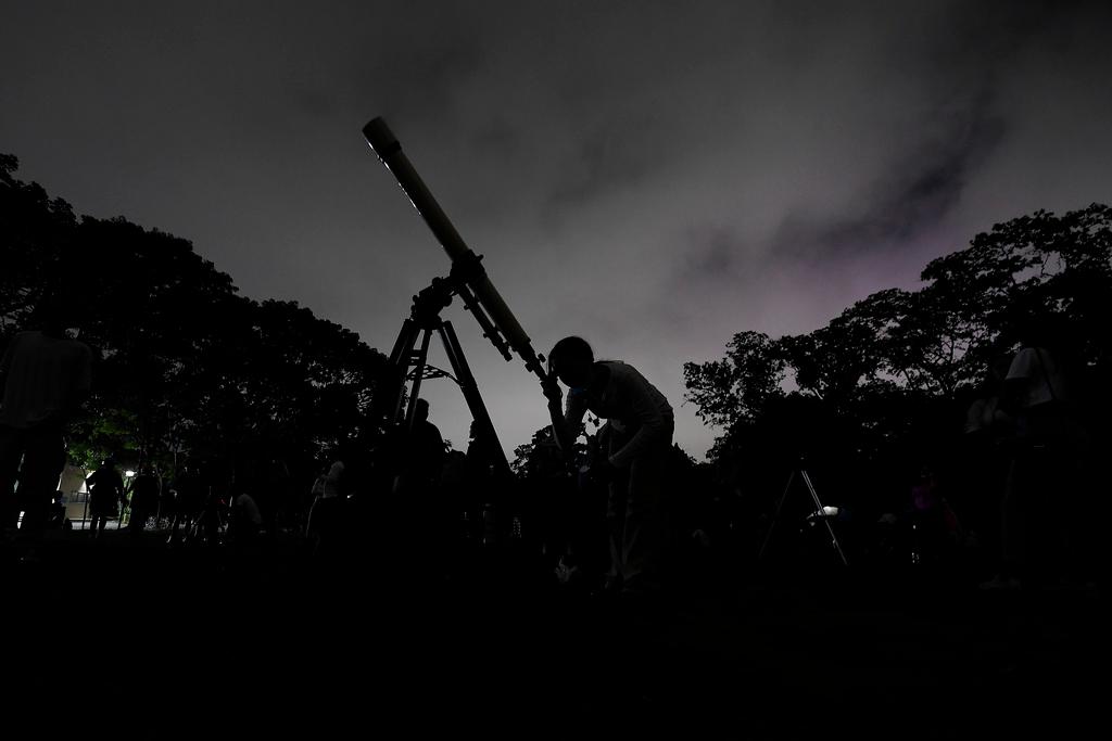 A girl looks at the moon through a telescope in Caracas, Venezuela, on Sunday, May 15, 2022.