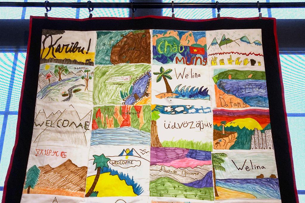 A handmade blanket, featuring "Welcome" in many languages, is displayed as part of the Welcome Blanket exhibit at the Winooski Heritage Mill Museum in Winooski, Vt.