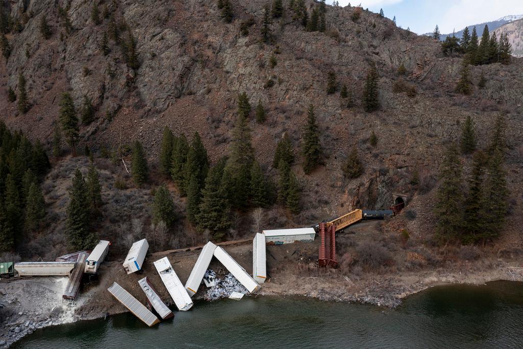 A train sits derailed near Quinn's Hot Springs Resort west of St. Regis, Mont.