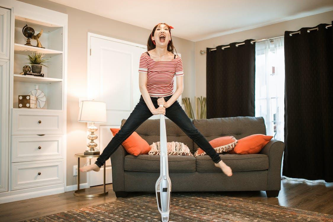 Woman jumping and Vacuuming