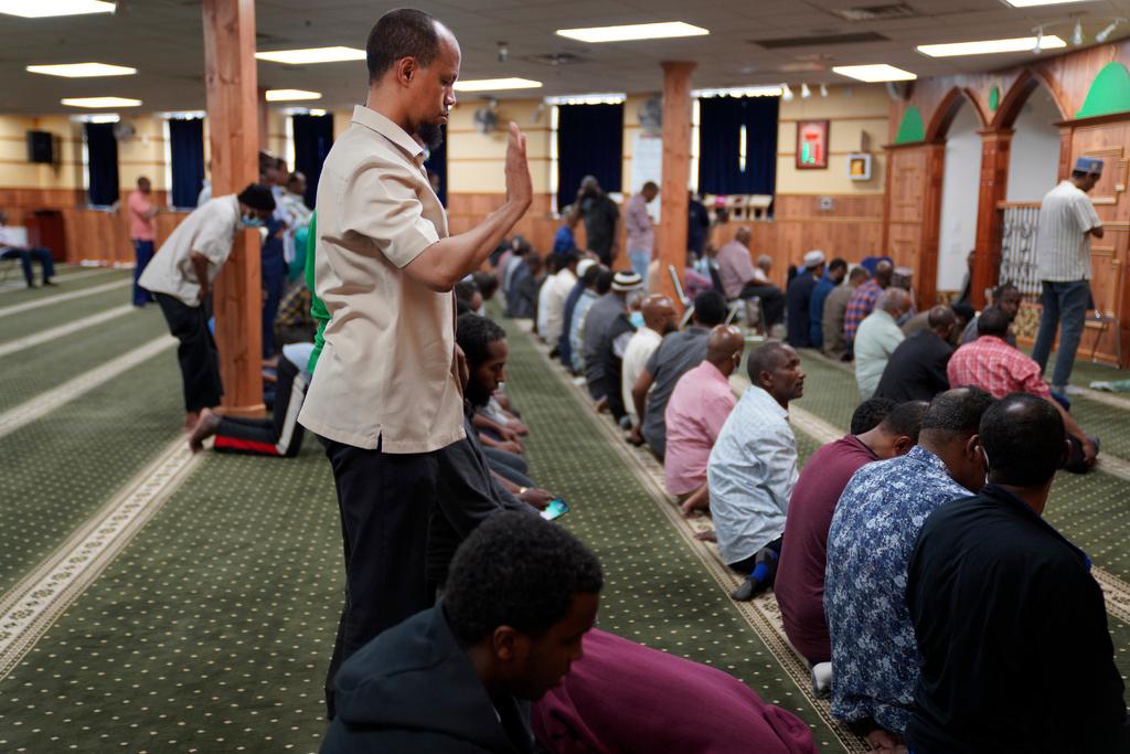 Yusuf Abdulle, standing, director of the Islamic Association of North America, prays with fellow Muslims at the Abubakar As-Saddique Islamic Center in Minneapolis