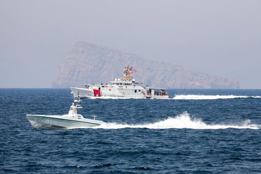 A U.S. Navy L3 Harris Arabian Fox MAST-13 drone boat and the U.S. Coast Guard cutter USCGC John Scheuerman transit the Strait of Hormuz 