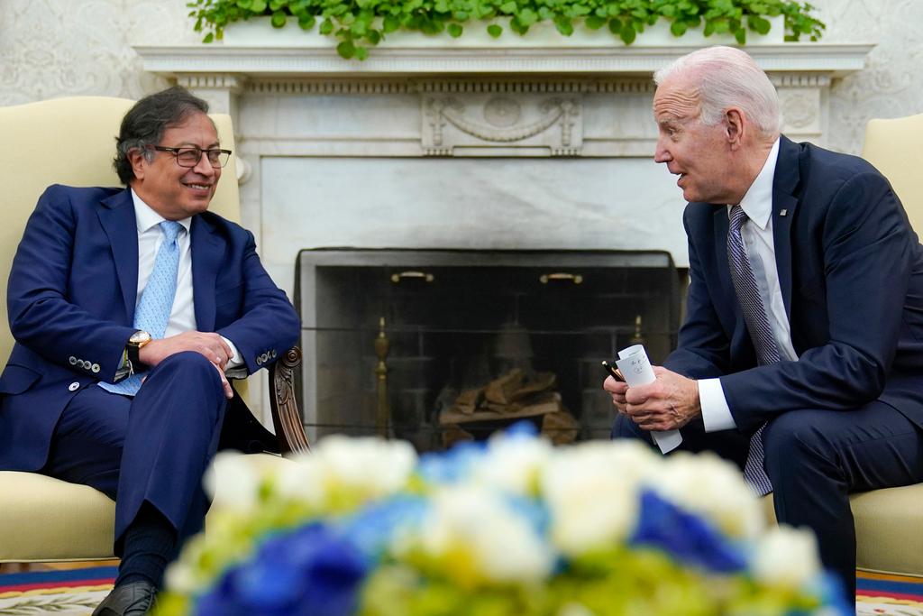 President Joe Biden leans over to speak with Colombian President Gustavo Petro as reporters yell questions after they gave statements in the Oval Office of the White House in Washington, Thursday, April 20, 2023.