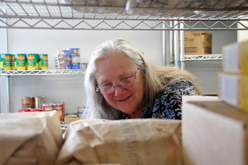 Rose Carney organizing supplies at the food pantry at Harvest Christian Fellowship Church in Eagle River, Alaska