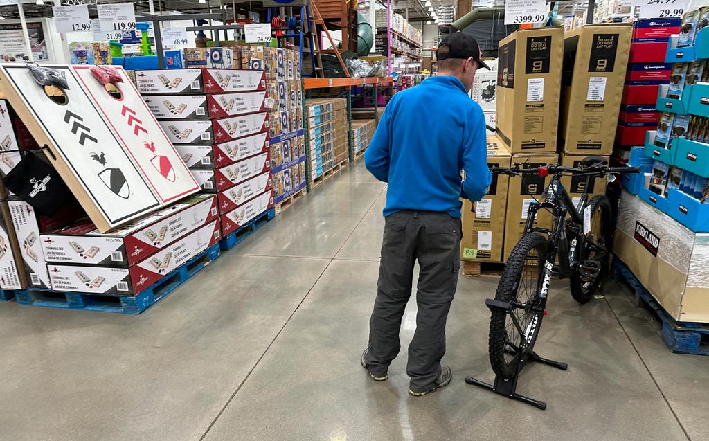 A shopper peruses a mountain bicycle on display in a Costco warehouse