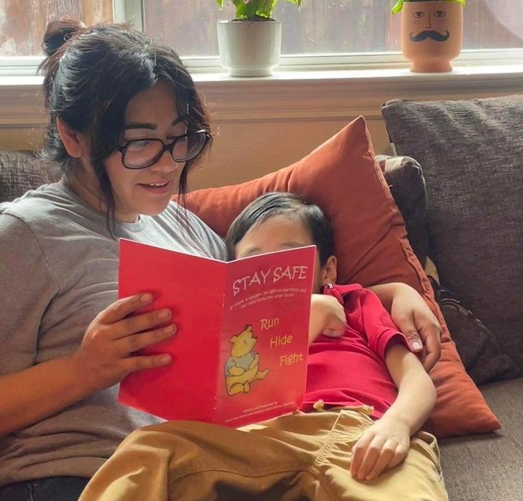 Cindy Campos reads the book "Stay Safe" to her son in Dallas. Cindy Campos' 5-year-old son was so excited about the book that had been sent home with him from school featuring Winnie-the-Pooh that he wanted to read it immediately. But her heart sank as she flipped through the pages advising children what to do if “danger is near.”