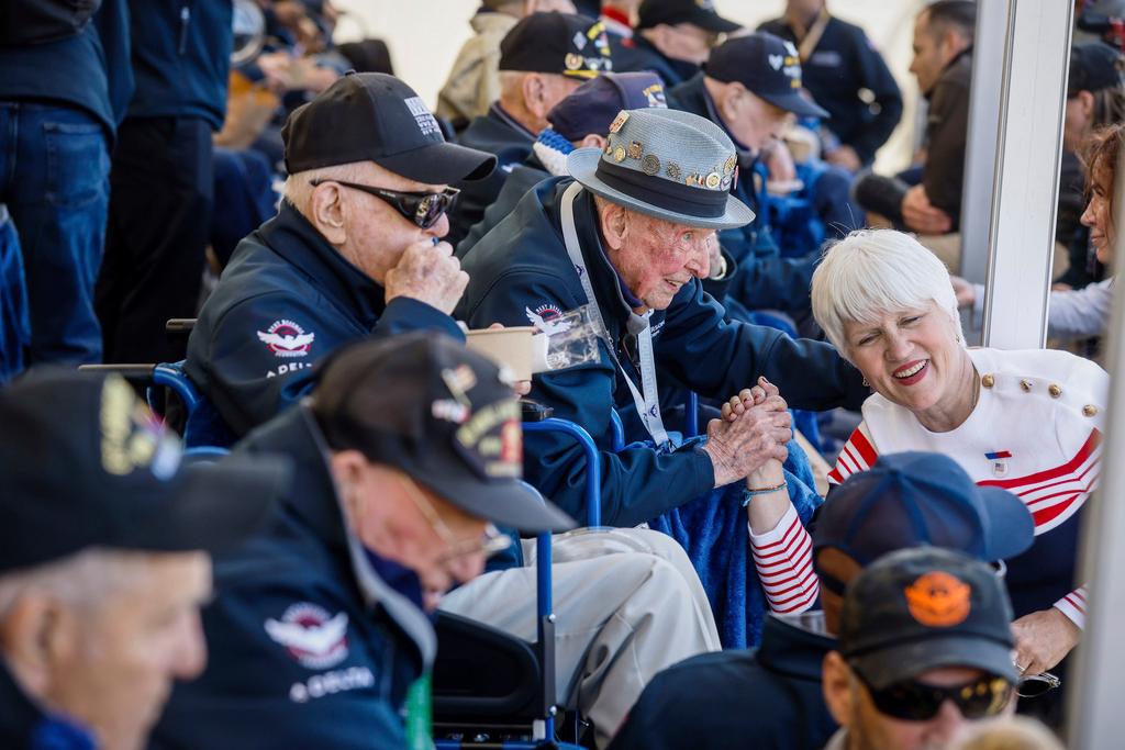 U.S. veteran SSgt. Jake M. Larson poses with a woman for a photograph during a gathering in preparation for the 79th D-Day anniversary in La Fiere, Normandy, France