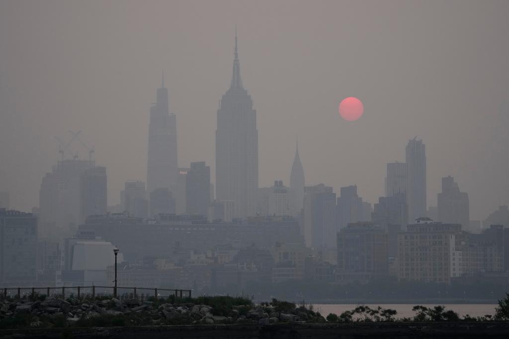 The sun rises over a hazy New York City skyline as seen from Jersey City, N.J., Wednesday, June 7, 2023.