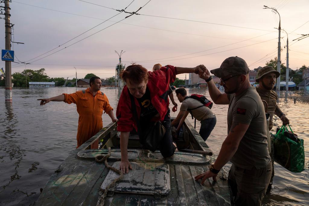 Volunteers evacuate a family from a flooded neighborhood in Kherson, Ukraine