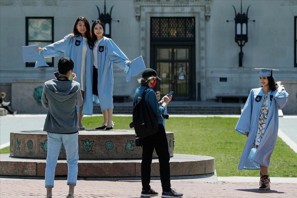 Columbia University class of 2020 graduates pose for photographs on Commencement Day