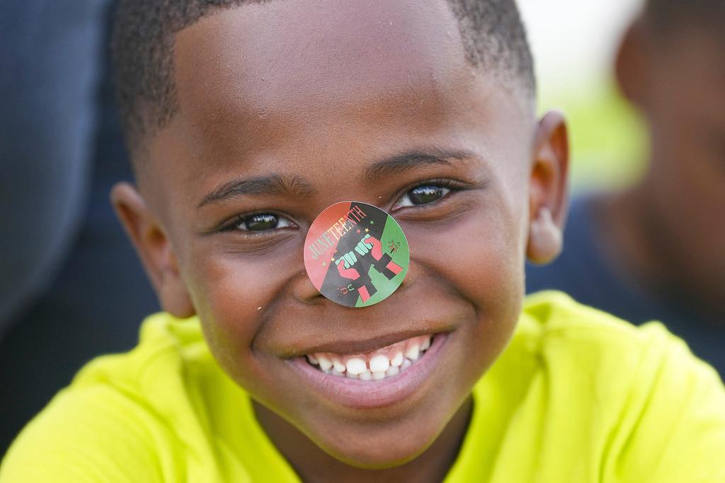 Laven Jackson, 5, smiles with a Juneteenth sticker on his nose during an unveiling event by City of Galveston 