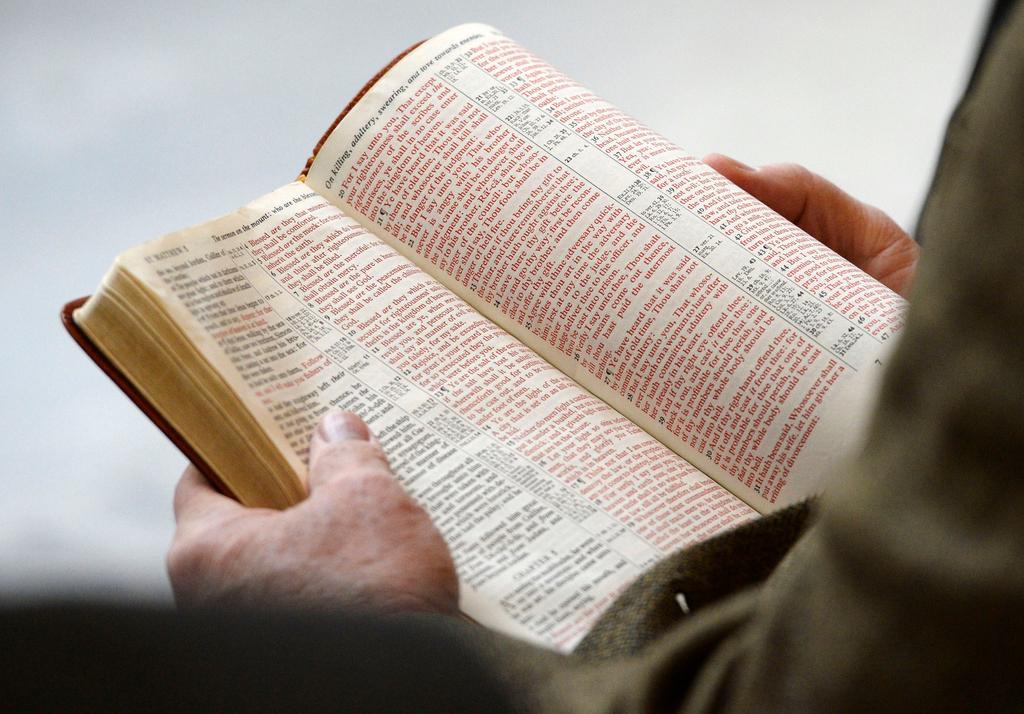 Man holding open Bible