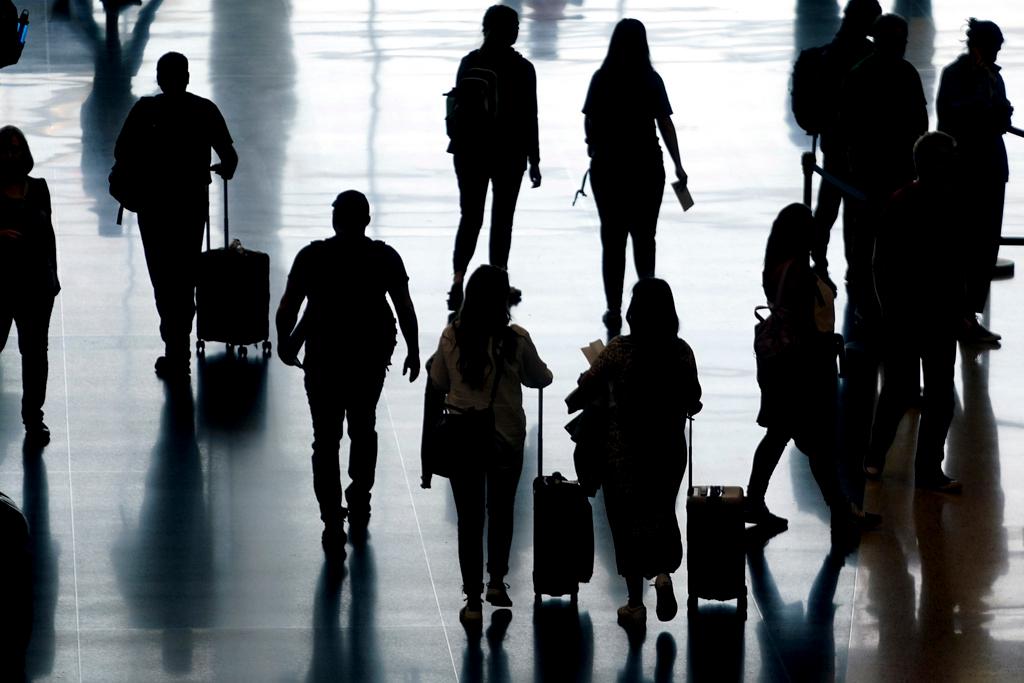 Travelers pass through Salt Lake City International Airport on June 27, 2022