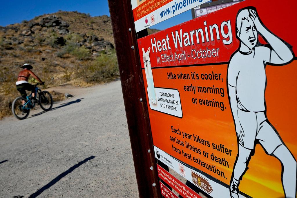 A cyclist finishes his ride early to beat high temperatures in Phoenix