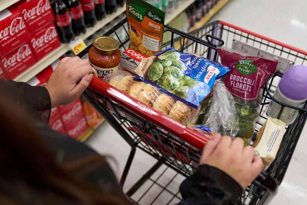 A food shopper pushes a cart of groceries at a supermarket in Bellflower, California