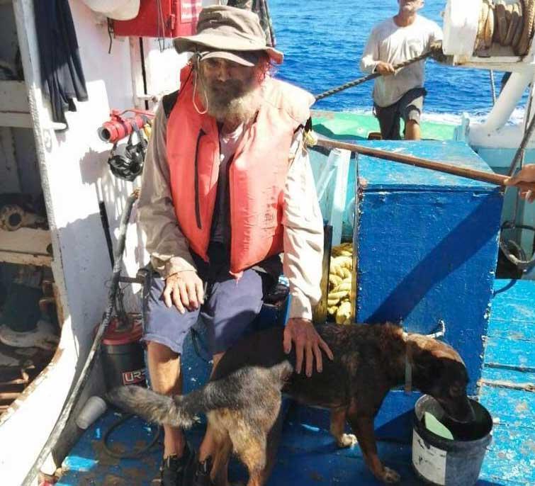 Tim Shaddock sits with his dog Bella after being rescued by a Mexican tuna boat in international waters