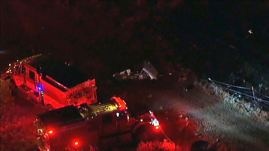 Aerial image taken from video provided by ABC7 Los Angeles shows the scene of a firefighting helicopter crash, with emergency vehicles at the base of a mountain and the area blocked off with police tape, in Cabazon, Calif.