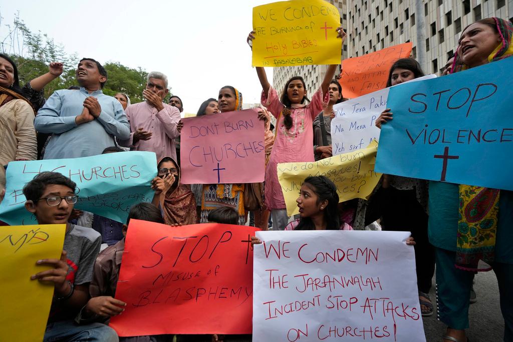 Members of Christian groups and others demonstrate to condemn the attack on a Christian area and a burned church by angry Muslim mob in Karachi, Pakistan