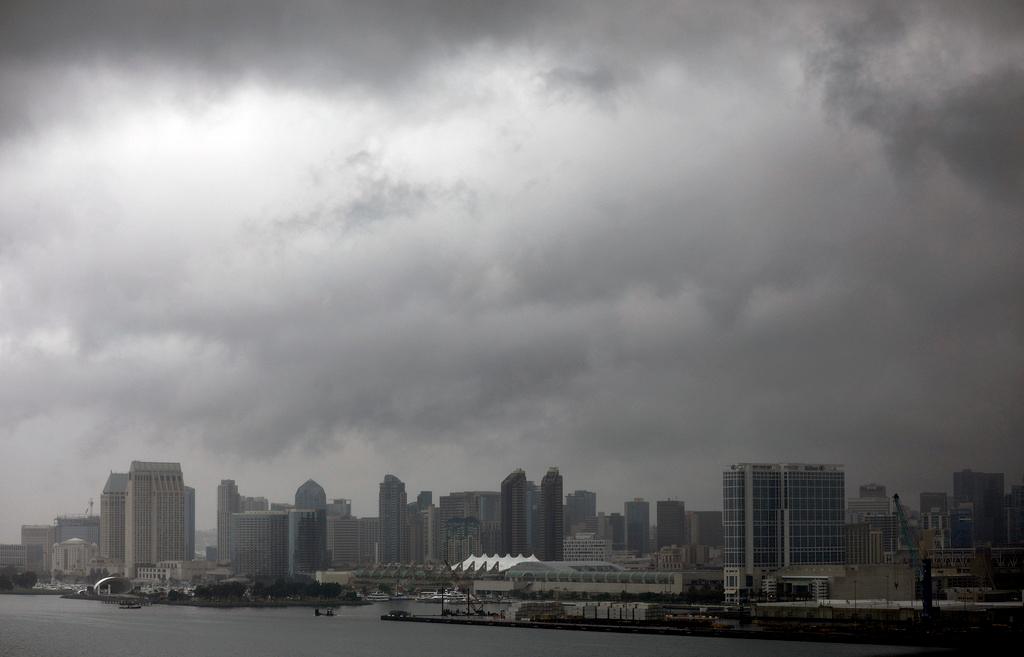 Dark clouds form over downtown San Diego as Tropical Storm Hilary passes through the area on Sunday, Aug. 20, 2023.