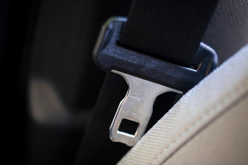 A seat belt for the right front passenger seat is shown in a vehicle