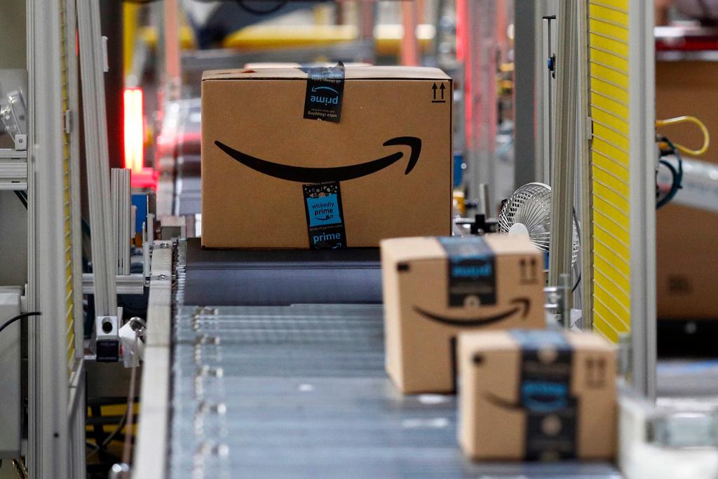 Packages pass through a scanner at an Amazon fulfillment center