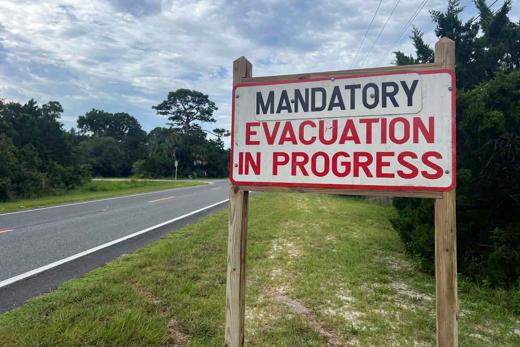 An evacuation sign stands in Cedar Key, Fla.