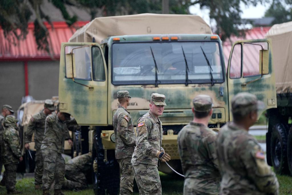 Members of the National Guard prepare their equipment in Mayo, Fla., as they wait for instructions on where to respond