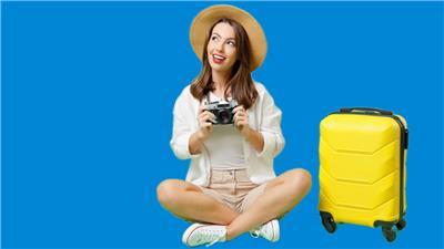 Woman with camera sitting down next to suitcase