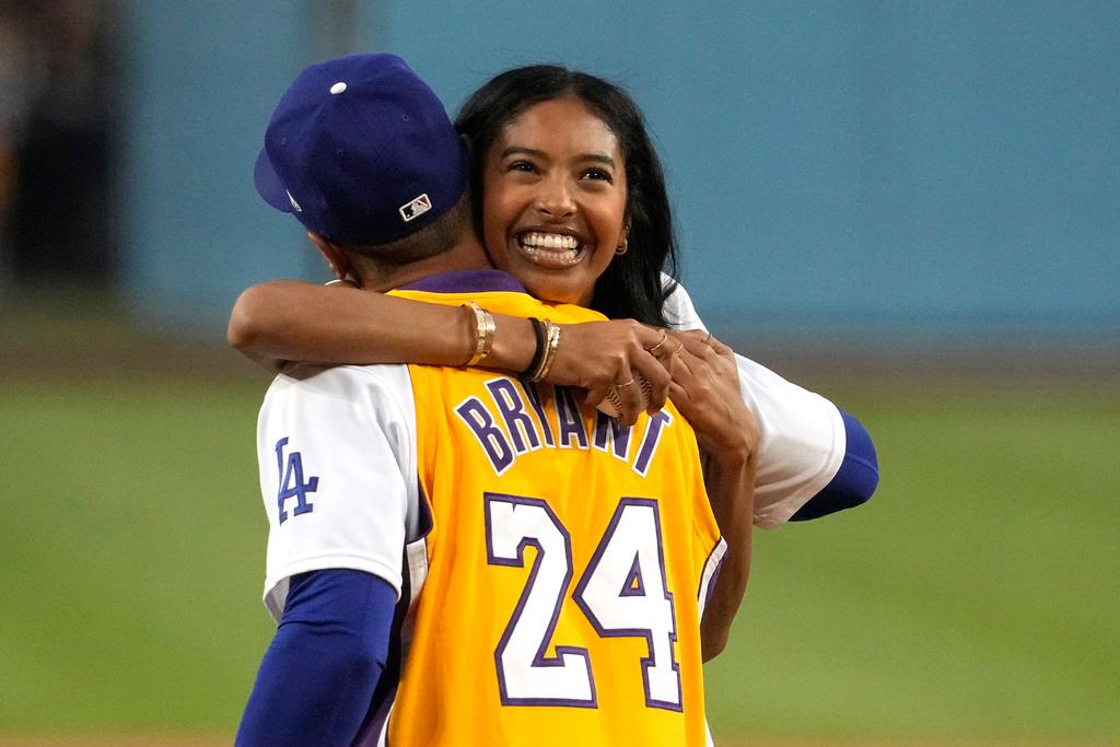 Natalia Bryant, daughter of Kobe Bryant, hugs Los Angeles Dodgers' Mookie Betts after throwing out the ceremonial first pitch prior to a baseball game between the Dodgers and the Atlanta Braves 